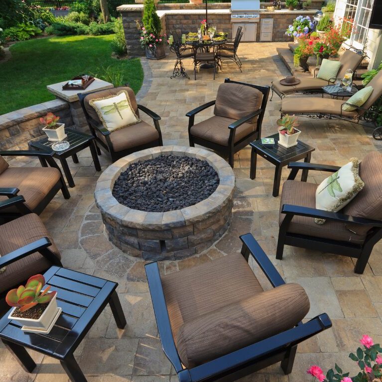 A stone fire pit on patio with seating