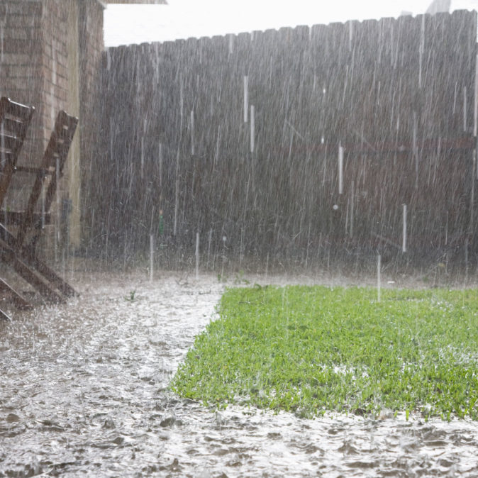 rain creating flooding in backyard by fence line